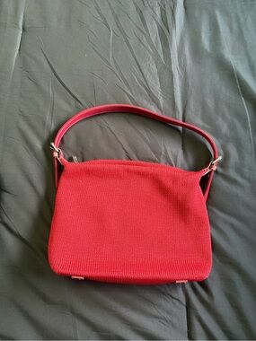 The Sak red textured knit handbag.